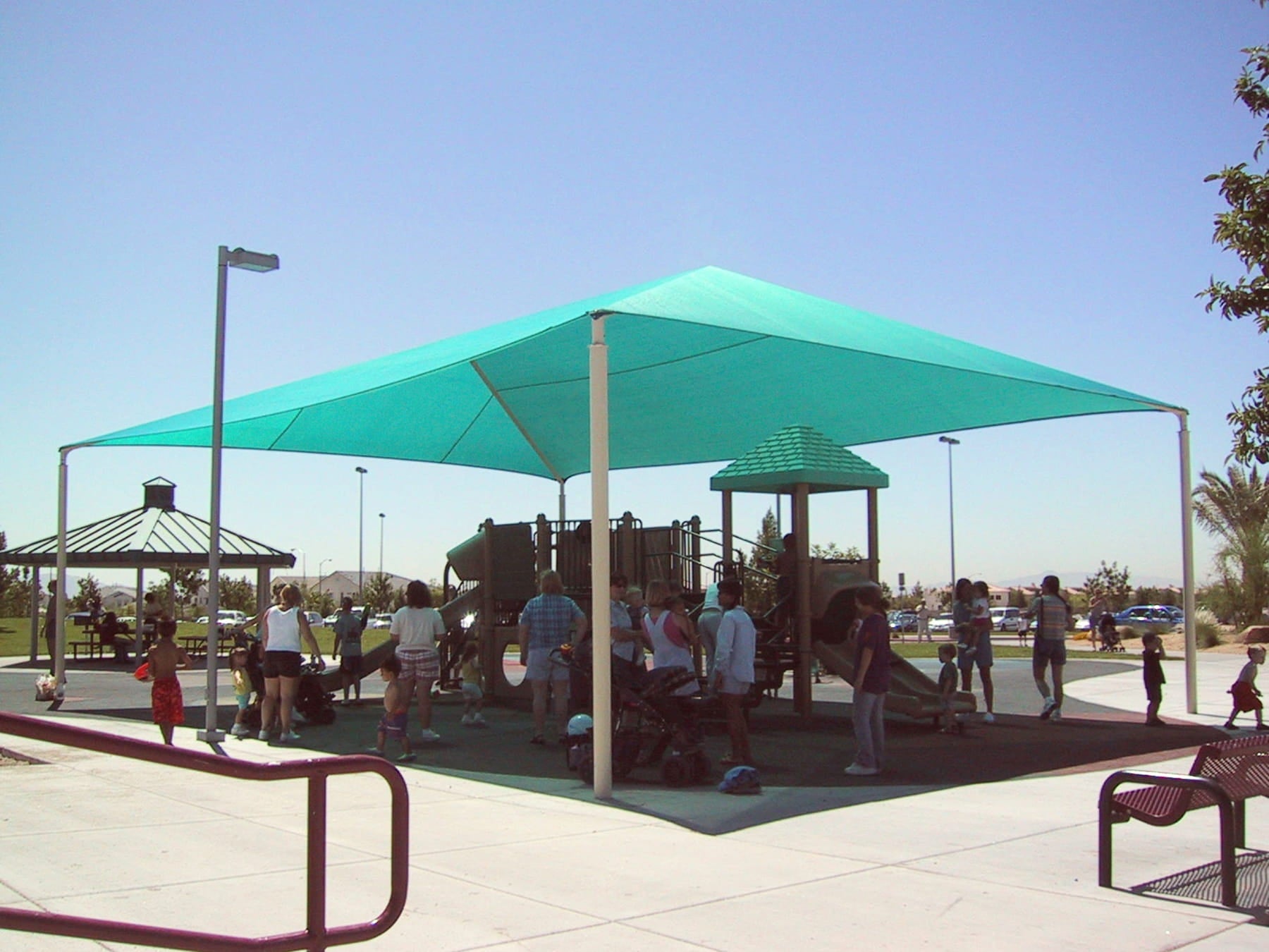 Children's playground with a Teal USA Shade Hip on a sunny day