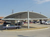 USA Shade Full Arch Cantilever with multiple cars parked underneath on a clear day