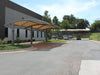 USA Shade Panorama Cantilever Covered parking area in front of a building with trees in the background