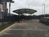 Covered parking area with a USA Shade Panorama Cantilever in an outdoor setting