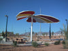 Large decorative USA Shade Butterfly Wings Shade in a desert-like setting with mountains in the background