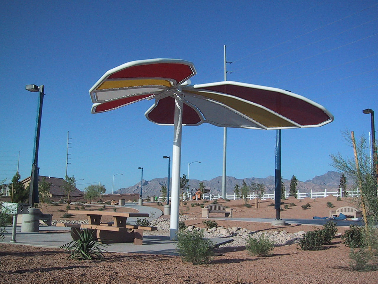 Large decorative USA Shade Butterfly Wings Shade in a desert-like setting with mountains in the background