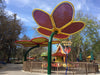 Colorful USA Shade Flower Shade Structure with 'Granny Bugs' sign in a park setting