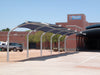 USA Shade Cantilever Arch Walkway with a building in the background on a clear day