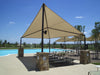Beige outdoor USA Shade Wave Shade with Brick base near a pool area