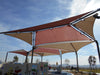 Large outdoor USA Shade Multi-Panel Hip Shade with a blue sky background