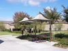 Picnic area with tables and USA Shade Solana Cantilevers in a park setting