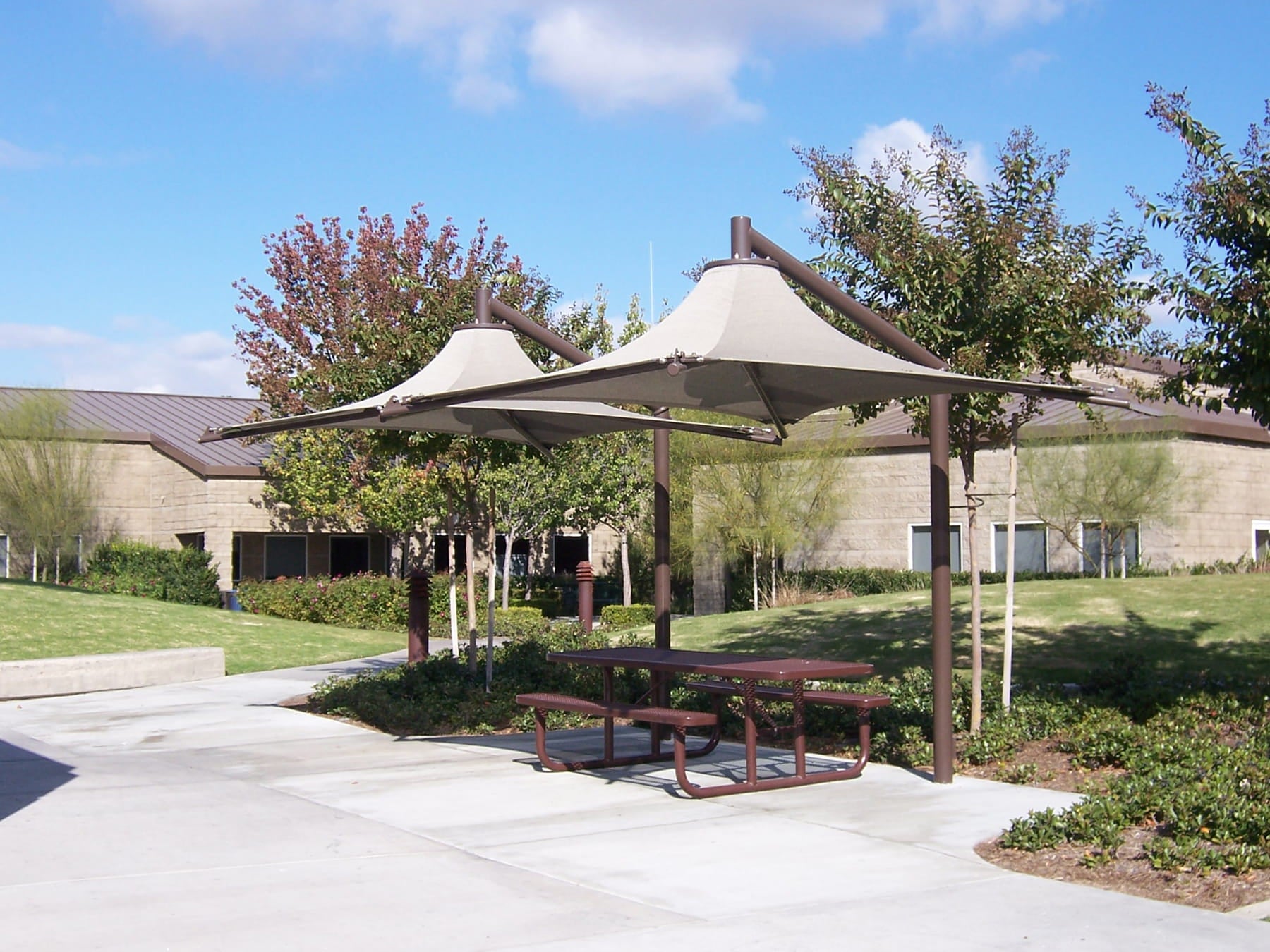 Picnic area with tables and USA Shade Solana Cantilevers in a park setting