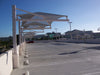 Parking lot with white USA Shade Tri-Truss Cantilever shade structures on a clear day