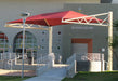 Red USA Shade Tri-Truss Cantilever over a gym entrance with 'GYMNASIUM' sign on a building.