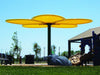 Children's playground with a large yellow USA Shade Flower Shade Structure and slide on a clear day.
