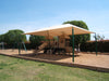 Playground with a USA Shade Hip providing shade on a sunny day.
