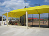 Yellow USA Shade Wrap-around Hip over a baseball field with people sitting underneath on a sunny day.