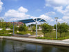 USA Shade Panorama Cantilever by a water body with trees and buildings in the background
