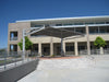 Modern building exterior with a large outdoor USA Shade Tri-Truss Cantilever shade