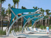 Modern beach chairs with a blue USA Shade Pegasus Shade in a tropical setting
