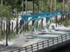 Modern outdoor seating area with blue USA Shade Pegasus Shades.