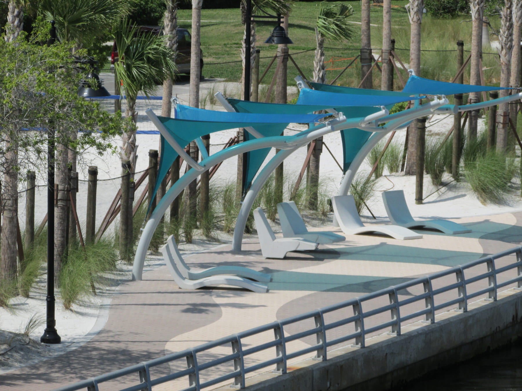 Modern outdoor seating area with blue USA Shade Pegasus Shades.