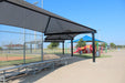 USA Shade Wrap-around Hip covering seating area with bleachers at a sports field, featuring a playground in the background.